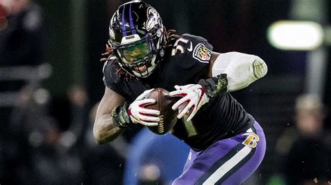 CJ Mosley in Baltimore Ravens uniform making a tackle on the field